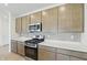 Modern kitchen featuring stainless steel appliances, abundant cabinets, and a stylish tile backsplash at 5763 Greenbrier Ct, Brownsburg, IN 46112