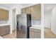 Contemporary kitchen features stainless steel refrigerator, modern cabinets, and white countertops at 5763 Greenbrier Ct, Brownsburg, IN 46112