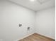 Clean laundry room with wood flooring and hookups for a washer and dryer at 5763 Greenbrier Ct, Brownsburg, IN 46112