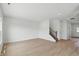 A bright, spacious living room showcases natural light, hardwood floors, and a staircase leading to upper level at 5763 Greenbrier Ct, Brownsburg, IN 46112