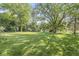 The property showcases a large, well-maintained backyard lawn with mature trees and shrubbery at 5841 N Parker Ave, Indianapolis, IN 46220
