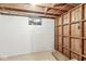 This unfinished basement features painted walls, exposed studs, and a small window at 5841 N Parker Ave, Indianapolis, IN 46220