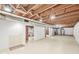 Spacious unfinished basement with painted block walls, painted concrete floor, and exposed joists at 5841 N Parker Ave, Indianapolis, IN 46220