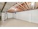 Unfinished basement with painted walls, exposed ceiling, water heater, and block foundation at 5841 N Parker Ave, Indianapolis, IN 46220