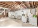 Unfinished basement space with laundry area, concrete floor, and exposed ceiling at 5841 N Parker Ave, Indianapolis, IN 46220
