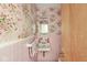Bathroom with pink floral wallpaper and vanity sink at 5841 N Parker Ave, Indianapolis, IN 46220