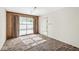 Dining room includes wood paneling, carpet flooring, a light fixture, and a door at 5841 N Parker Ave, Indianapolis, IN 46220