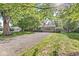 Charming single Gathering home with a sprawling front yard and a long gravel driveway at 5841 N Parker Ave, Indianapolis, IN 46220