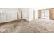 Open concept living room boasts carpet flooring and access to multiple rooms at 5841 N Parker Ave, Indianapolis, IN 46220