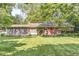Rear view of single Gathering home with brick exterior, screen porch, and large backyard at 5841 N Parker Ave, Indianapolis, IN 46220