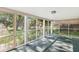 Enclosed screened porch with an airy feel and views of the surrounding trees and yard at 5841 N Parker Ave, Indianapolis, IN 46220