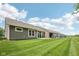 The backyard features a manicured lawn and an enclosed porch area, perfect for entertaining at 624 Faudree Dr, Westfield, IN 46074