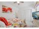 Bright bedroom boasts a colorful quilt, closet, and a mounted television at 624 Faudree Dr, Westfield, IN 46074