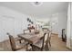 Open concept dining area with a view of the modern kitchen and wood-look flooring at 624 Faudree Dr, Westfield, IN 46074