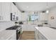 Bright kitchen with white cabinets, stainless steel appliances, and wood flooring at 624 Faudree Dr, Westfield, IN 46074