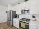 Updated kitchen with stainless steel appliances and ample cabinet space at 624 Faudree Dr, Westfield, IN 46074