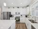 Spacious kitchen with stainless steel appliances, ample counter space, and wood flooring at 624 Faudree Dr, Westfield, IN 46074