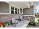 Inviting covered porch with brick accents, comfortable seating, and charming decorative details at 624 Faudree Dr, Westfield, IN 46074