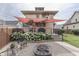 Charming backyard with a fire pit area, lush hydrangeas, and a shaded deck at 629 S Miller St, Shelbyville, IN 46176