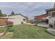 Spacious backyard with a lush lawn, charming flower bed, and partially visible home at 629 S Miller St, Shelbyville, IN 46176