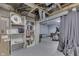 Unfinished basement with shelving, book case, workout machine and utility area at 629 S Miller St, Shelbyville, IN 46176
