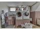 Basement laundry area with sink, washer and dryer with tile floor and a window at 629 S Miller St, Shelbyville, IN 46176
