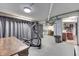 Finished basement area with workout machine, gray curtain, concrete floor, and utility area at 629 S Miller St, Shelbyville, IN 46176