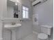 Bathroom features subway tile, pedestal sink, and classic black and white mosaic floor at 629 S Miller St, Shelbyville, IN 46176