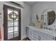 Bathroom features double vanity with marble counters and hardwood floors at 629 S Miller St, Shelbyville, IN 46176