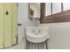 Charming bathroom featuring a vintage sink, wood window trim, and neutral decor at 629 S Miller St, Shelbyville, IN 46176