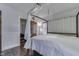 Bright bedroom features a canopy bed, hardwood floors, and natural light at 629 S Miller St, Shelbyville, IN 46176
