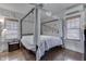 Primary bedroom featuring a canopy bed and neutral colors, with window blinds at 629 S Miller St, Shelbyville, IN 46176