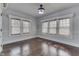 This well lit bedroom has natural window treatments and hardwood floors at 629 S Miller St, Shelbyville, IN 46176