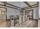 Dining room featuring wood floors, woven chairs, coffered ceiling, and modern lighting at 629 S Miller St, Shelbyville, IN 46176