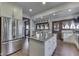 Open kitchen showcasing stainless steel appliances, an island, and seamless access to the dining area at 629 S Miller St, Shelbyville, IN 46176