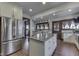 Well-lit kitchen boasting stainless steel appliances, a large island, and ample storage at 629 S Miller St, Shelbyville, IN 46176