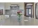 Kitchen island area of open concept area featuring flowers, island, stainless appliances, and dark trim at 629 S Miller St, Shelbyville, IN 46176