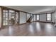 Open concept living room with wood floors and access to stairs and dining room at 629 S Miller St, Shelbyville, IN 46176