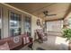 Inviting front porch with comfortable seating, a ceiling fan, and decorative wreath at 629 S Miller St, Shelbyville, IN 46176
