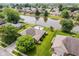 Drone shot of home showing in-ground pool, large backyard, and lovely pond views at 6629 Woodcrest Dr, Avon, IN 46123