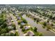 Aerial view of the neighborhood with homes lining a pond, some with private pools at 6629 Woodcrest Dr, Avon, IN 46123