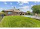 Home exterior displaying fenced backyard, well-maintained lawn, and in-ground pool at 6629 Woodcrest Dr, Avon, IN 46123