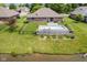 Aerial view of a backyard featuring an in-ground pool, deck, and fenced yard bordering a pond at 6629 Woodcrest Dr, Avon, IN 46123