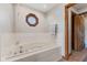Bright bathroom features a soaking tub, and a distinctive window at 6629 Woodcrest Dr, Avon, IN 46123