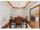 Elegant dining room featuring coffered ceilings, chandelier, and an adjacent view to the kitchen at 6629 Woodcrest Dr, Avon, IN 46123