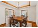 Bright dining room with a coffered ceiling, chandelier, and hardwood floors open to other living areas at 6629 Woodcrest Dr, Avon, IN 46123