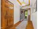 Inviting foyer with hardwood floors, decorative ceiling trim, and an open doorway leading outside at 6629 Woodcrest Dr, Avon, IN 46123