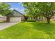 Charming single-story brick home featuring an attached two-car garage and a well-maintained lawn at 6629 Woodcrest Dr, Avon, IN 46123