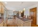 Kitchen featuring an island with seating, hardwood floors, and an open layout at 6629 Woodcrest Dr, Avon, IN 46123