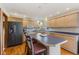 Kitchen with wood cabinetry, a large island with seating, and modern appliances at 6629 Woodcrest Dr, Avon, IN 46123